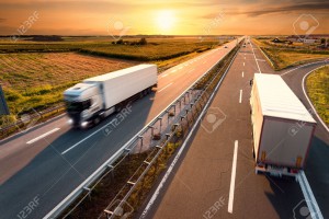 30797317-Two-trucks-on-highway-in-motion-blur-at-sunset-Stock-Photo-truck-road-delivery